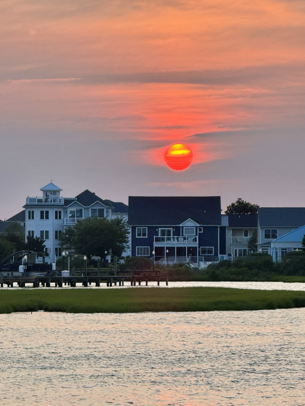 Sunset over the bay with silhouetted houses in Ocean City